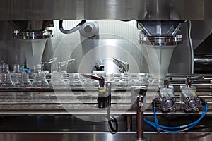 Pharmaceutical industry, medicine pills are filling in the plastic bottle on production line machine conveyor at the medical