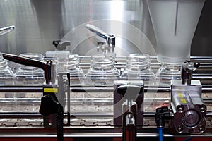 Pharmaceutical industry, medicine pills are filling in the plastic bottle on production line machine conveyor at the medical