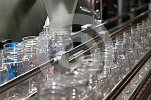 Pharmaceutical industry, medicine pills are filling in the plastic bottle on production line machine conveyor at the medical