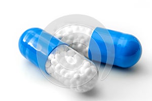 Pharmaceutical industry, pain management drugs and medication concept theme with macro close up on two blue and transparent pills photo