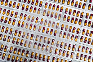 Pharmaceutical industry. Red-yellow capsule pills in blister pack. Pharmaceutical packaging. Pharmacy product. Global healthcare.