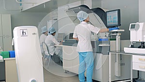 Pharmaceutical laboratory with working specialists in a modern bright laboratory.