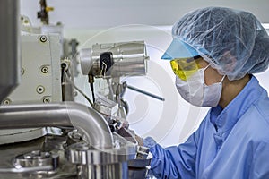 Pharmaceutical Machine Operator In Protective Clothing