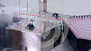 Pharmaceutical manufacturing line. Medical ampoules on production line