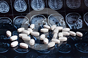 Pharmaceutical medicine pills on magnetic brain resonance scan mri background. Pharmacy theme, health care, drug prescriptio