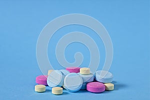 Pharmaceutical pills, tablets, medication on blue background