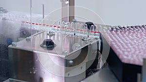 Pharmaceutical production line. Medical vials on automated production line