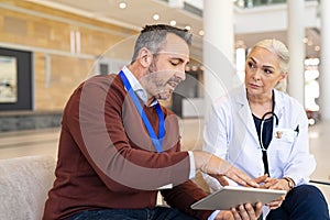 Pharmaceutical representative showing test results of new medicine to doctor