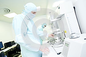 Pharmaceutical researcher working with granulate and powder flow photo
