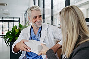 Pharmaceutical sales representative presenting new medication to doctor in medical building.