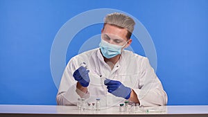 A pharmaceutical scientist fills a syringe with the Covid-19 coronavirus vaccine. Study of a cure for an outbreak of