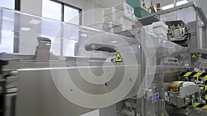 Pharmaceutical worker operates blister packaging machine