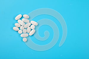 Pharmaceuticals Pills on a blue background. Empty space for text