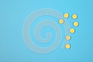 Pharmaceuticals, question mark made of pills and a bottle on a blue background. Copy space for text