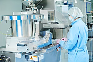 Pharmaceutics. Pharmaceutical worker operates blister packaging machine