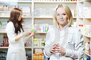 Pharmaceutist woman worker in drug store