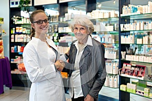 Pharmacist assisting an elderly lady