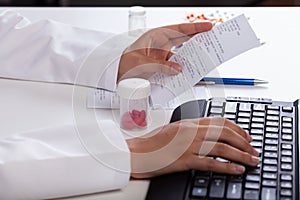 Pharmacist checking information about medicines