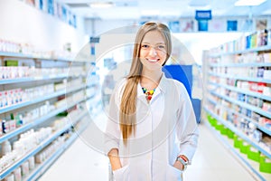 Pharmacist chemist woman standing in pharmacy photo