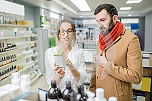 Pharmacist with client in the pharmacy store