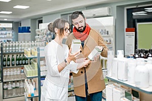 Pharmacist with client in the pharmacy store