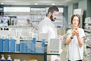 Pharmacist with client at the pharmacy store