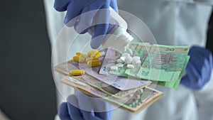 Pharmacist dropping pills on hryvnias, expensive medical treatments in Ukraine