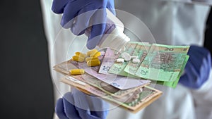 Pharmacist dropping pills on hryvnias, expensive medical treatments in Ukraine