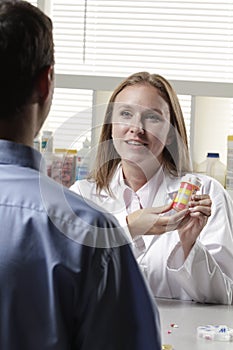 Pharmacist explaining prescription to patient