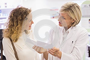 Pharmacist explaining the prescription to patient