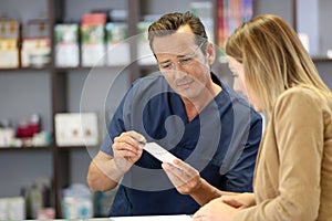 Pharmacist giving instructions to patient
