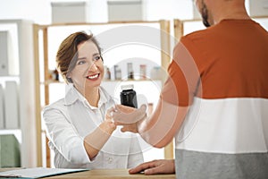 Pharmacist giving medicine to customer