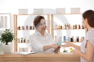 Pharmacist giving medicine to customer