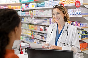 Pharmacist giving medicine to customer