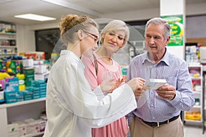 Pharmacist and her customers talking about medication