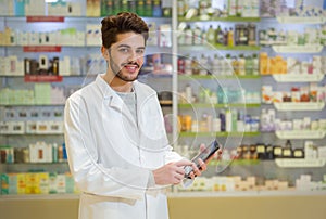 Pharmacist holding digital tablet in pharmacy