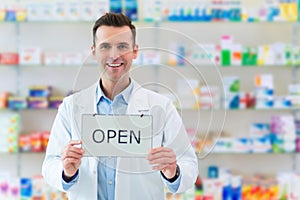 Pharmacist Holding An Open Sign photo
