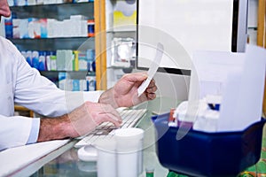 Pharmacist making entries on computer