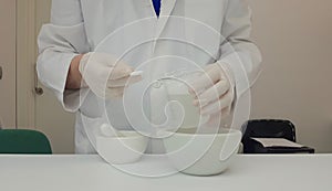 Pharmacist performing a quality control of effervescent tablets