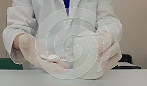 Pharmacist performing a quality control of effervescent tablets