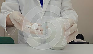 Pharmacist performing a quality control of effervescent tablets