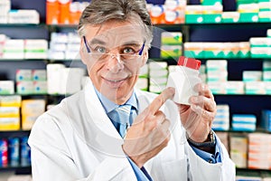 Pharmacist in pharmacy with medicament