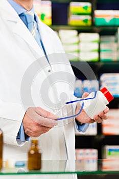 Pharmacist in pharmacy with medicament