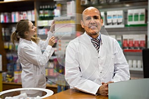 Pharmacist and pharmacy technician in drugstore