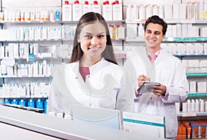 Pharmacist and pharmacy technician posing