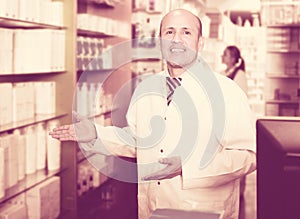 Pharmacist and pharmacy technician posing in modern farmacy