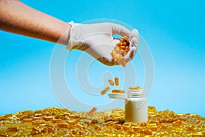 Pharmacist pouring drugs into his hand and counting pills on blue background.