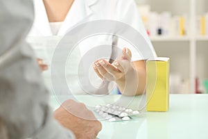 Pharmacist reading leaflet of a medicine to a patient photo