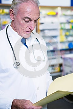 Pharmacist reading prescriptions