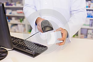 Pharmacist scanning medicines